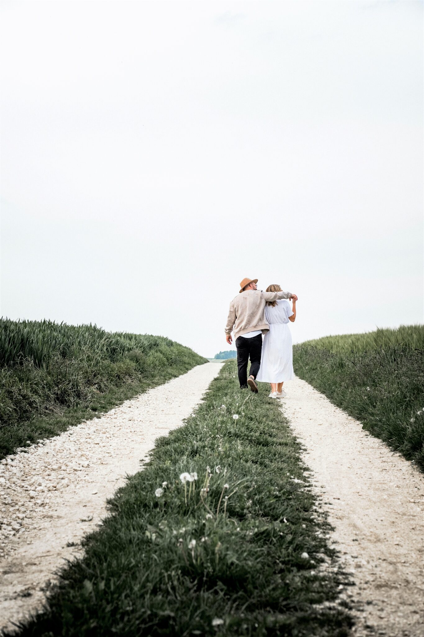 A couple stand together and are walking down a long path. This article covers how to maintain a healthy relationship after divorce.