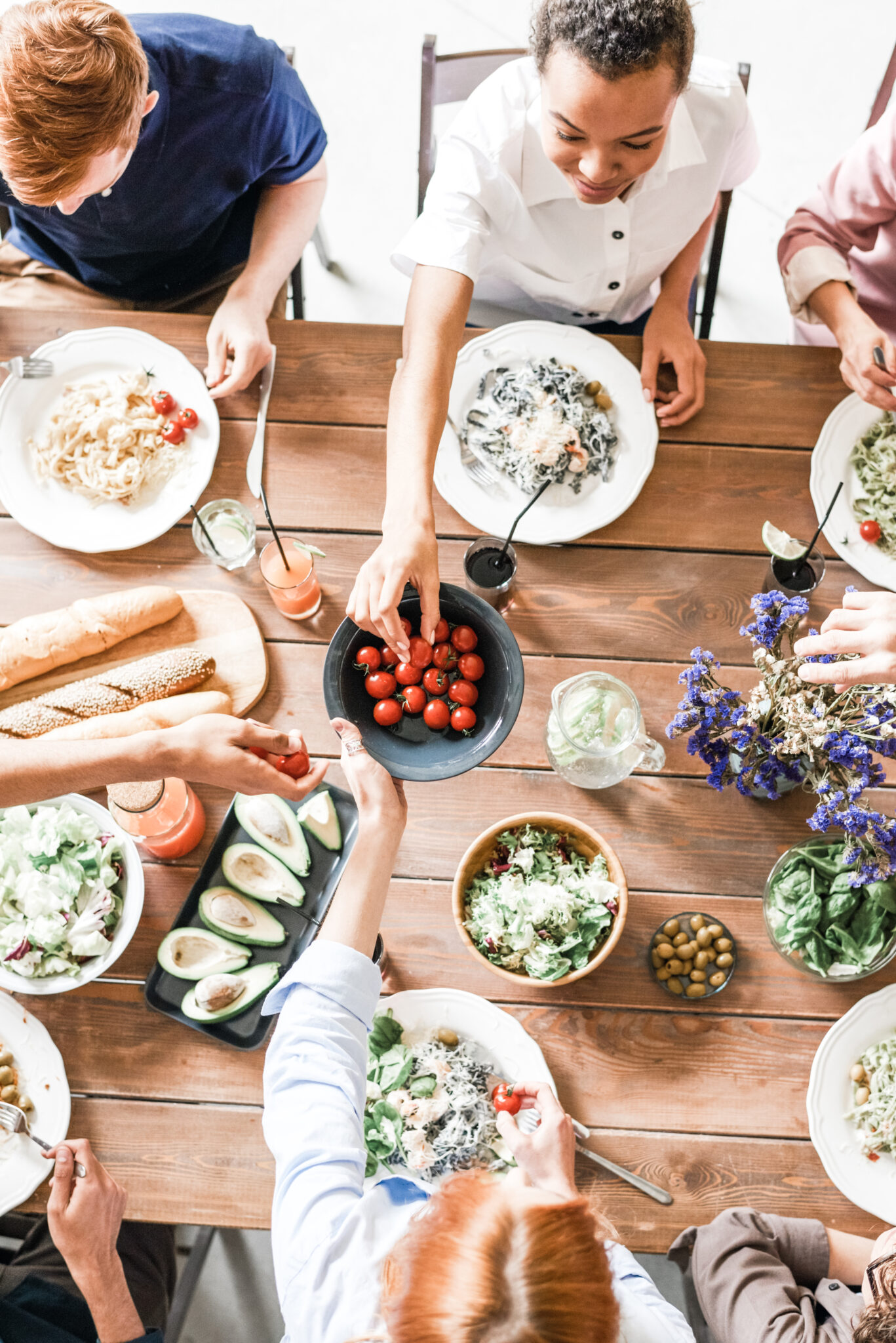 Family and friends are gathered around the table and are sharing a meal. This article covers how to improve your family dinners. 