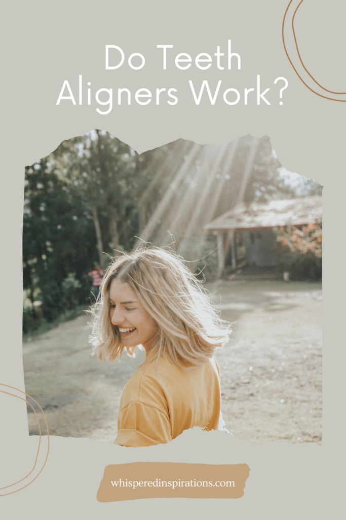 A woman is standing outside, looking back, and is smiling. The suns ray shine on her. This article covers how effective teeth aligners are.