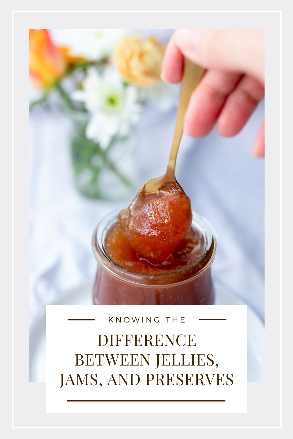 A spoon is being taken out of a glass container of jam. This article covers knowing the difference between jellies and jams.