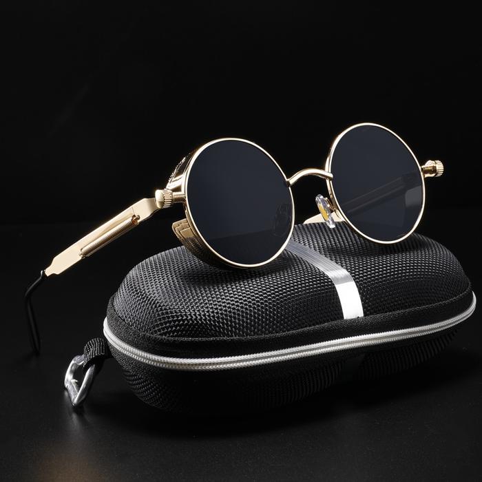 A pair of gold and black steampunk glasses sit on a black and silver case. These Jacob Steampunk Sunglasses are a best-seller. 