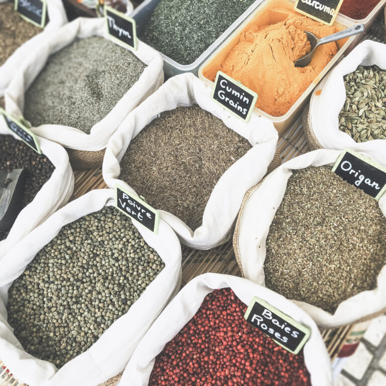 Spices with scoops that are being sold in bulk. This article covers 8 reasons why you should buy in bulk.