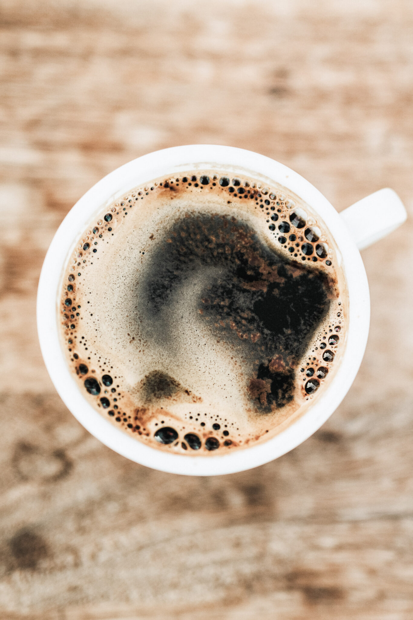 A top view of a freshly brewed cup of black coffee. This article covers what coffee you should drink based on your mood.