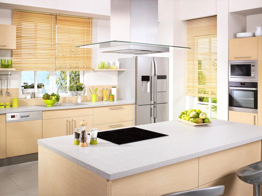 A warm and neutral kitchen that has pops of green everywhere. 