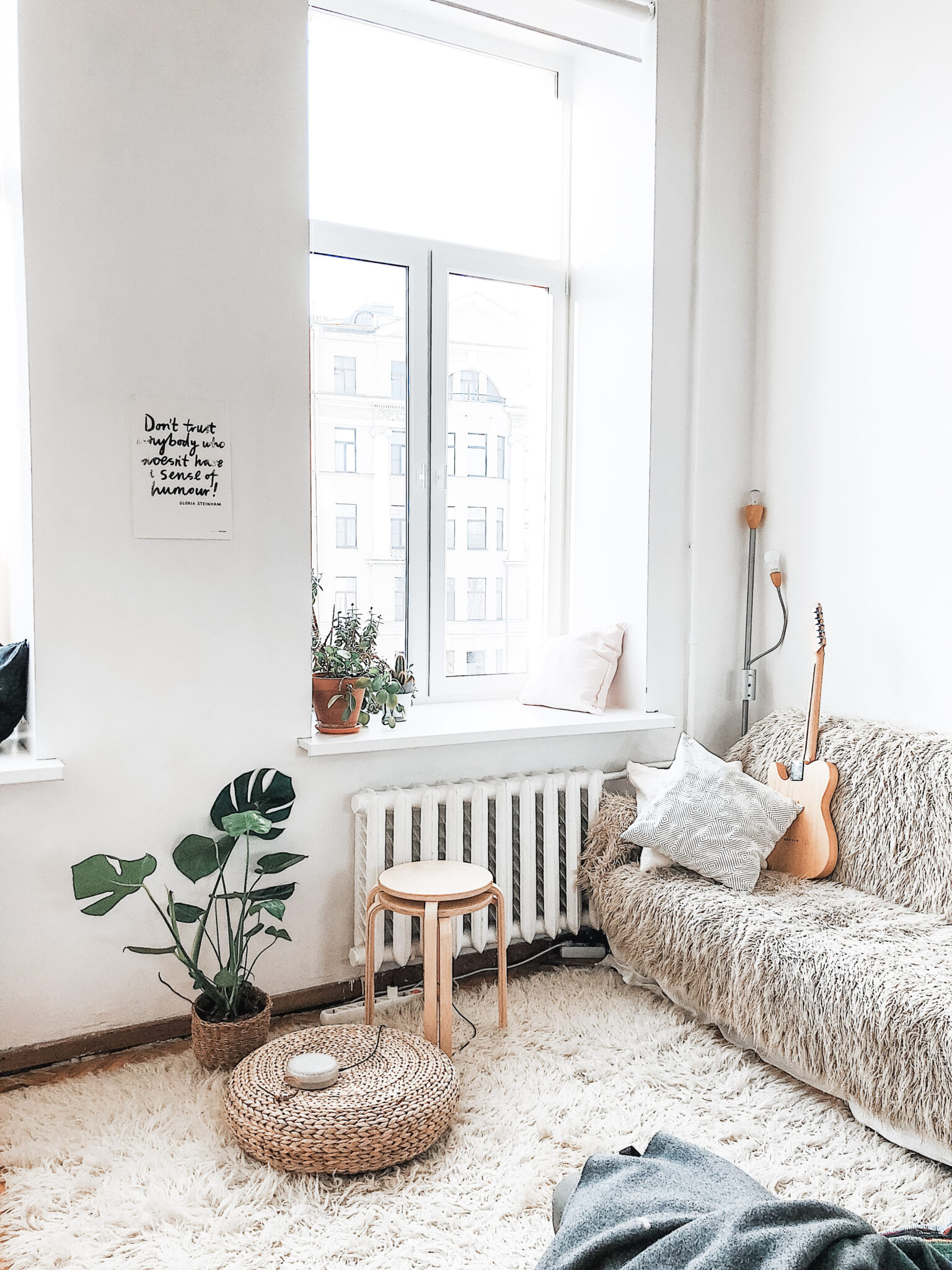 A bright and beautiful apartment is shown. The living area holds boho decor. This article covers how to rent an apartment.