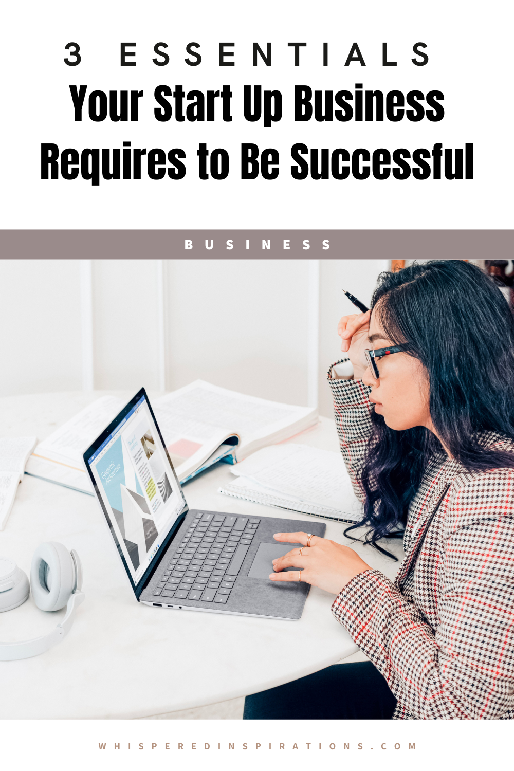 A woman sits at a desk working on a computer. She has a pen in hand and has it lifted by her head. This article covers essentials your startup business requires to be successful.