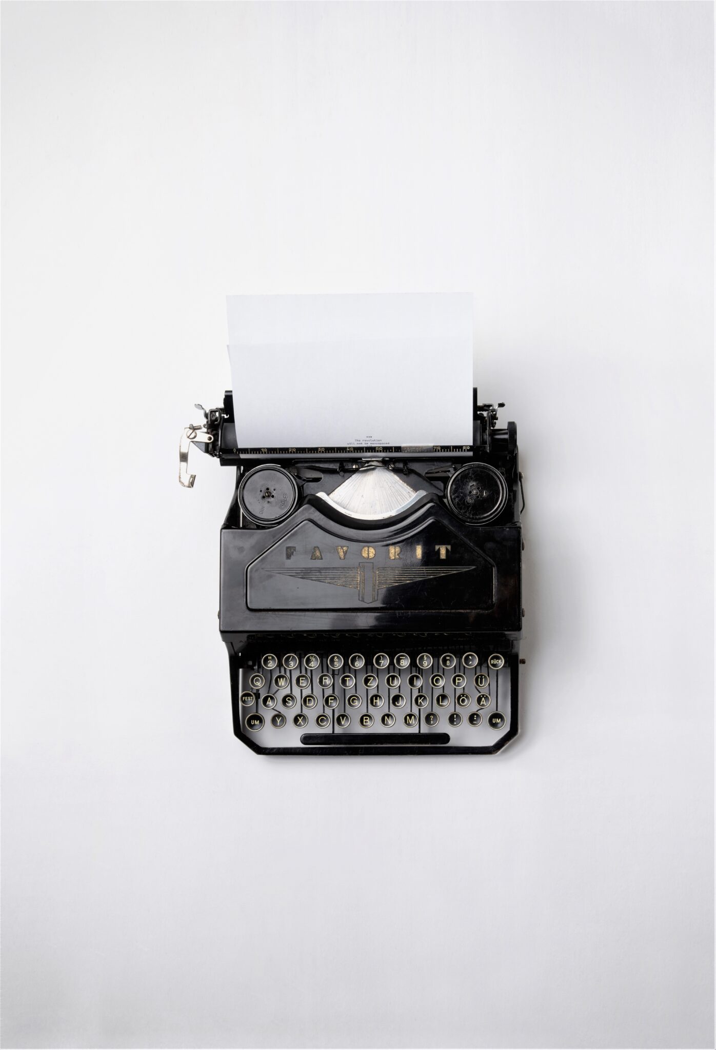 A vintage but working typewriter is pictured from a birds eye view and this article covers the benefit of essay writing.