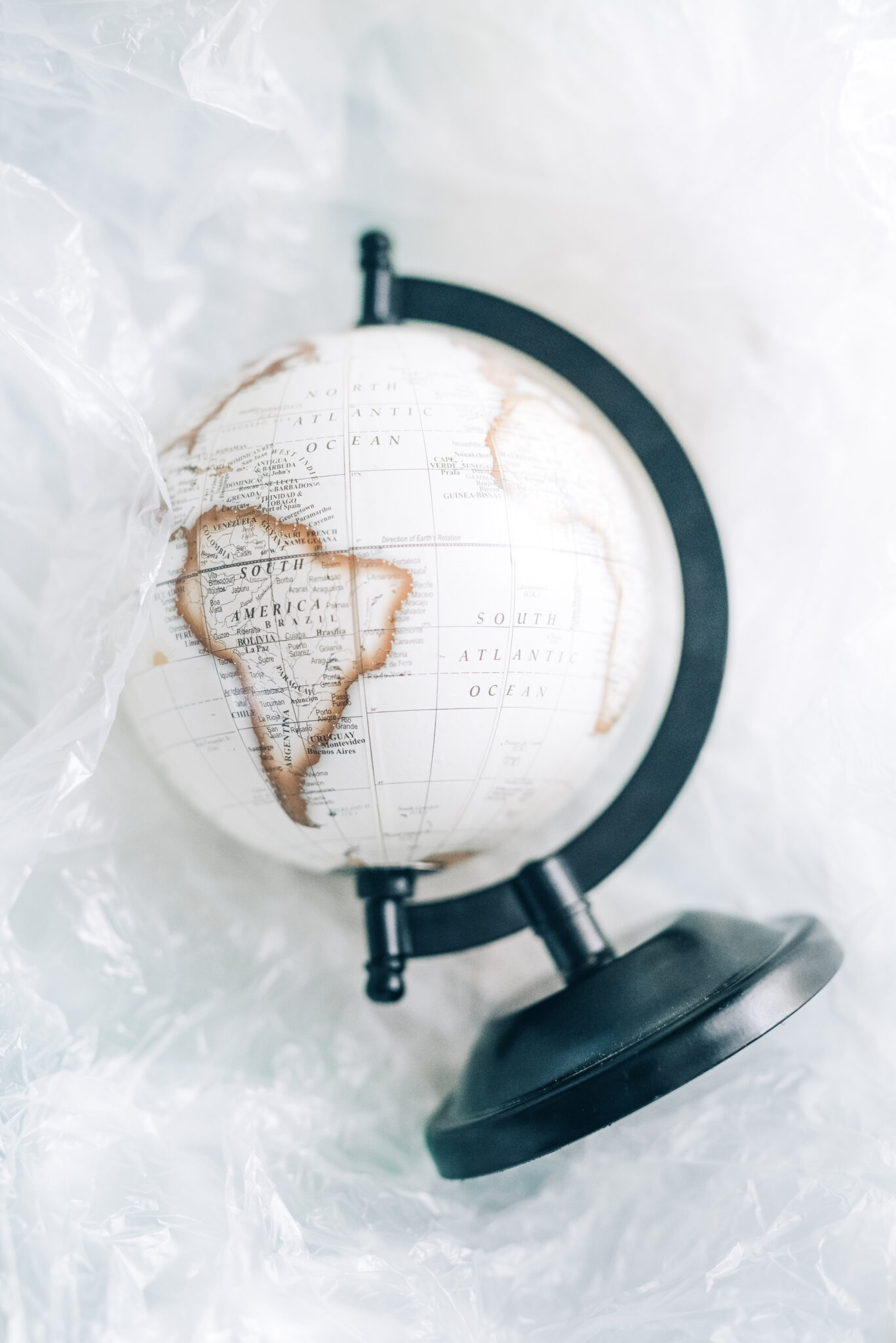 A beautiful white, black, and gold globe sitting in plastic wrap. This article covers what you have to remember if you want to emigrate.