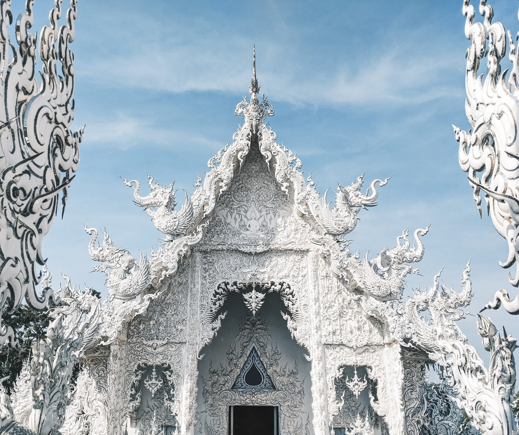The top of a the beautiful White Temple in Thailand. This article covers family-friendly things to do in Thailand.