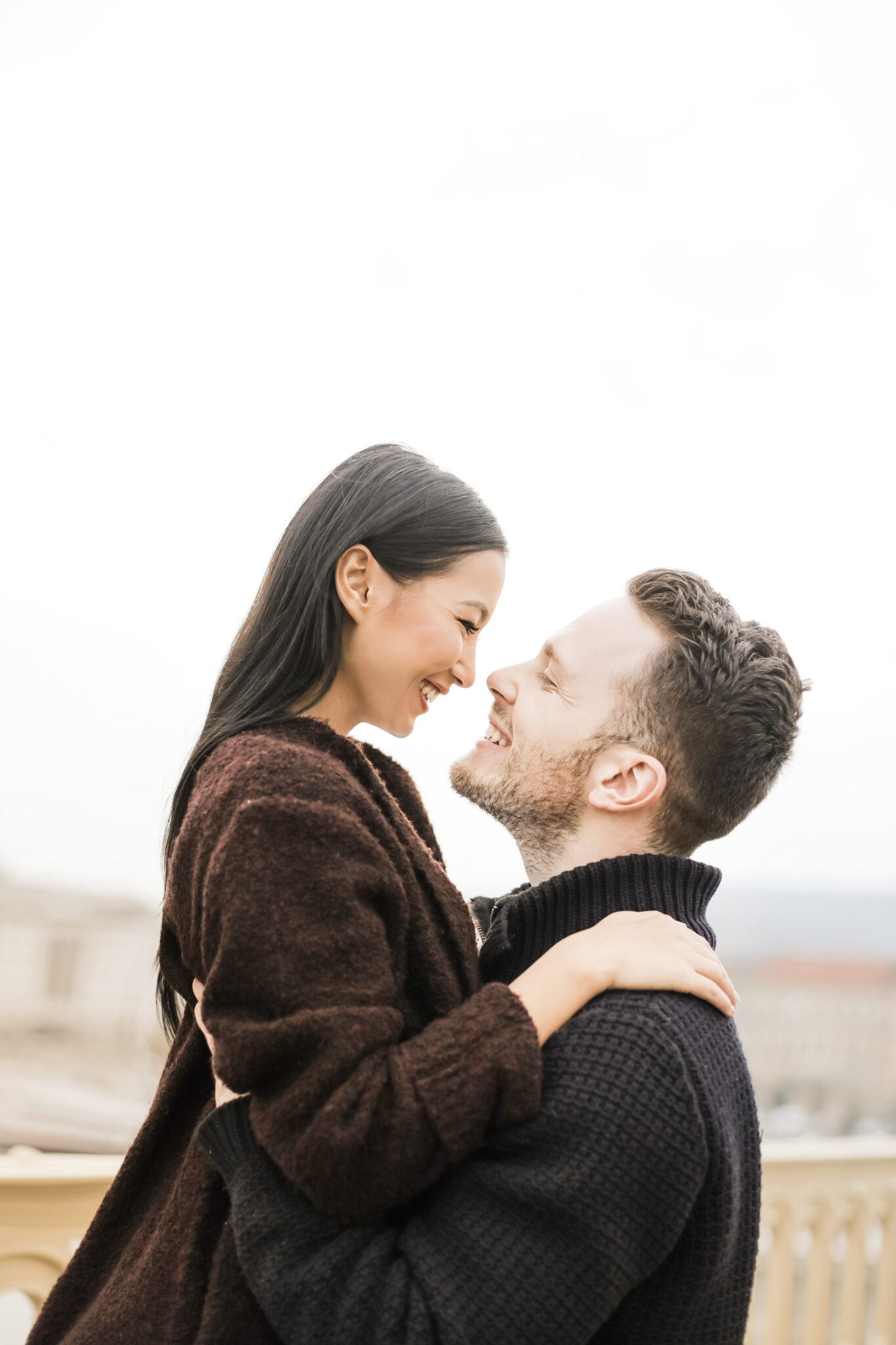 A man holds a woman up in his arms and they look at each other lovingly. This article covers tips for building a healthy romantic relationship.