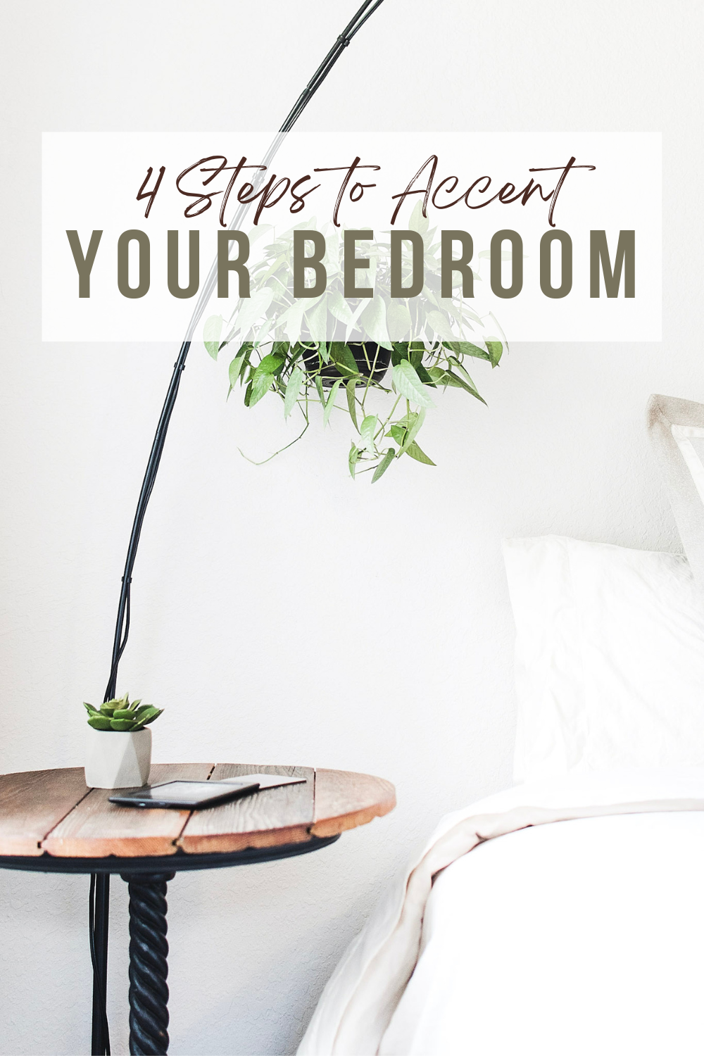 A beautiful and bright bedroom is shown with white sheets, a wood side table, an arched lamp, and hanging plant. This article covers 4 steps to accent your room.