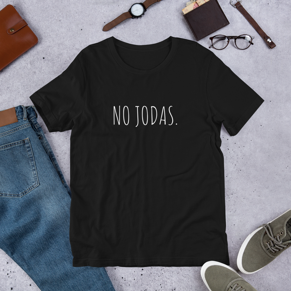 A black t-shirt that says, "No Jodas' is shown. It's an item from Whispered Inspirations Etsy Shop. 