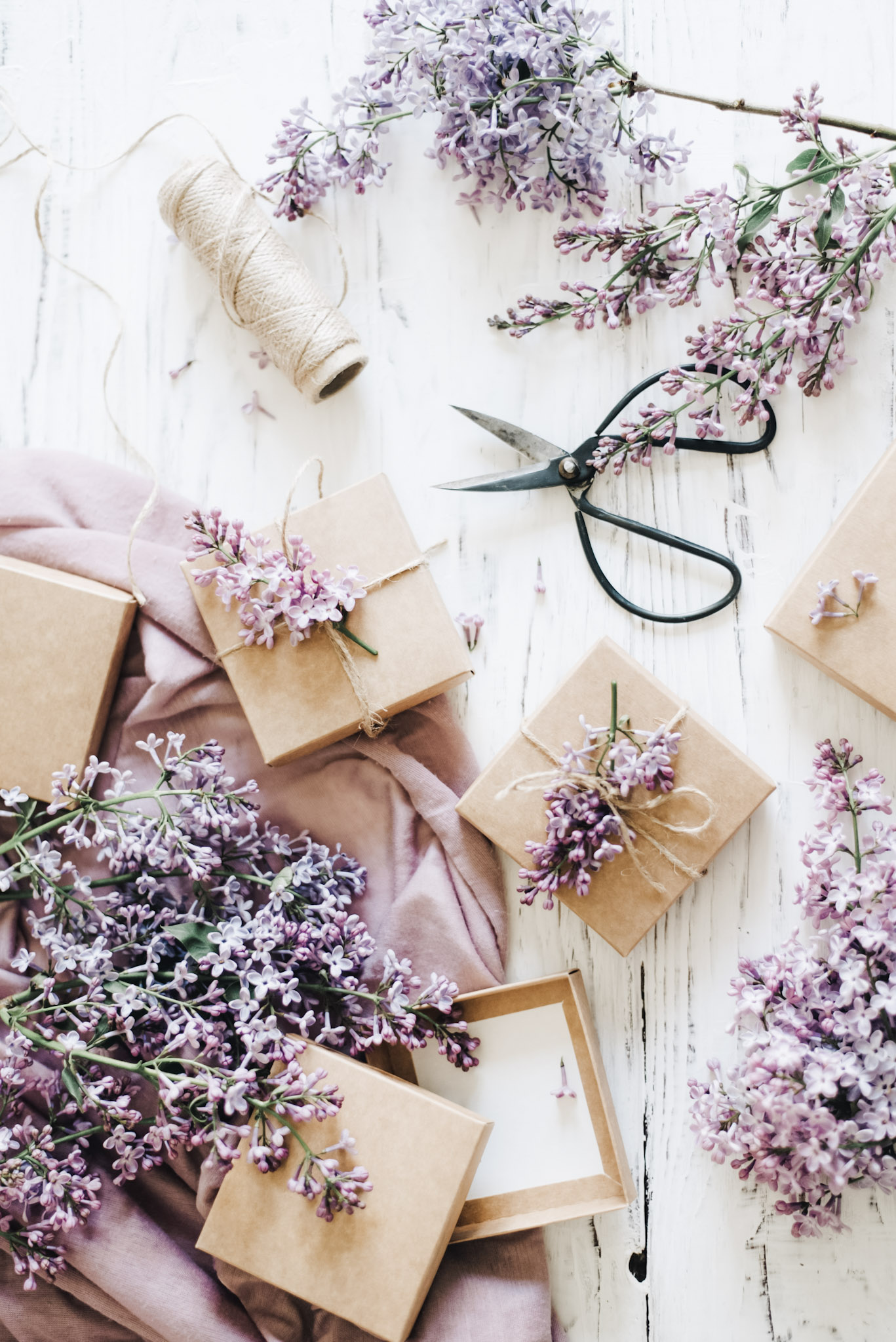 Sprigs of lavender, with scissors and string. Items used to wrap gifts. This article covers how to pick gifts that will surprise and delight.