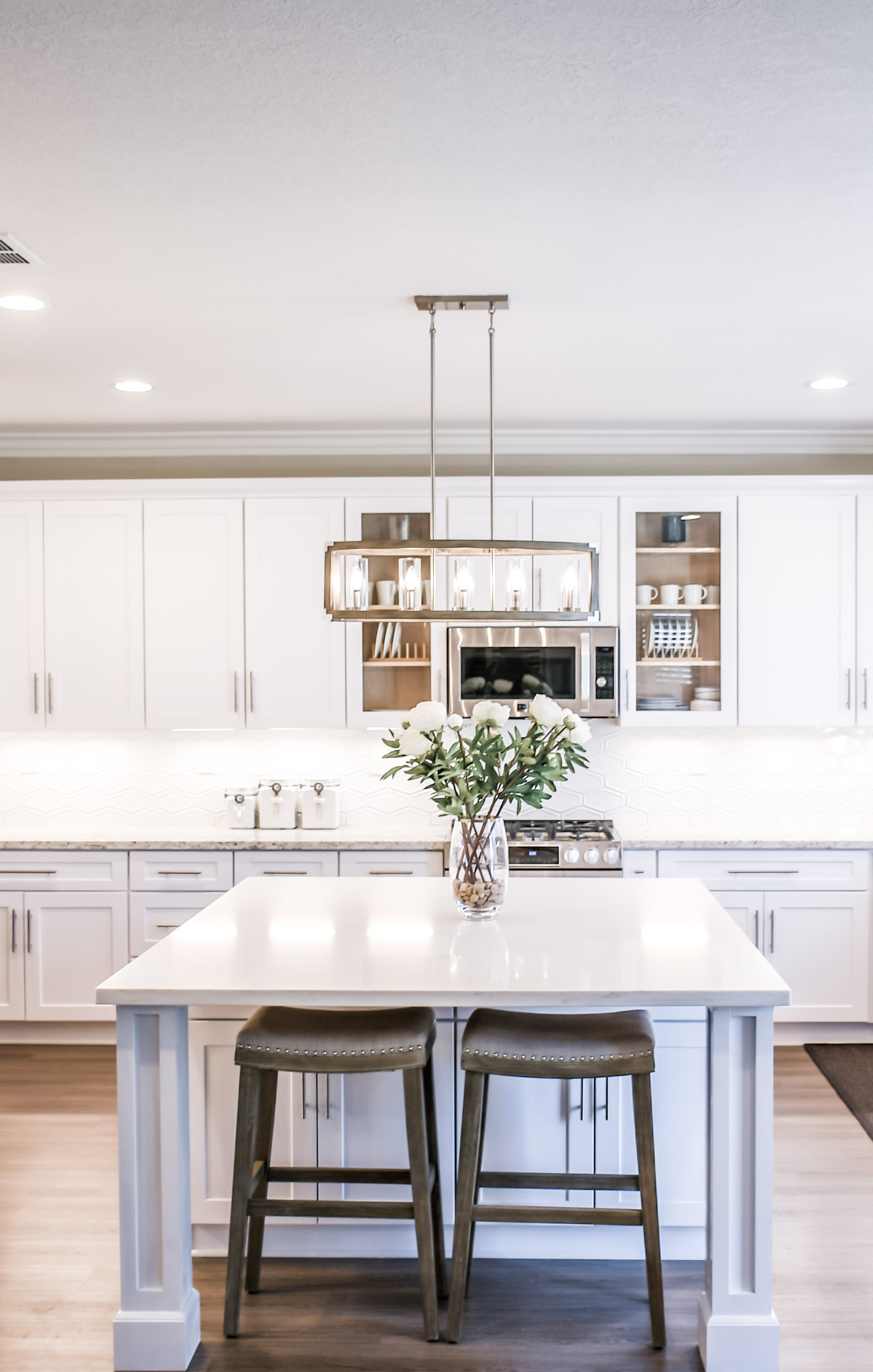 A beautiful, bright, and modern kitchen is shown. This article covers how to maintain the hygiene of your home from maximum health.