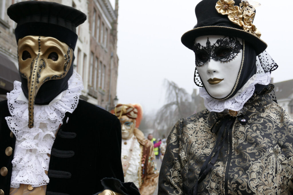 Two men in masks for Mardi Gras. 