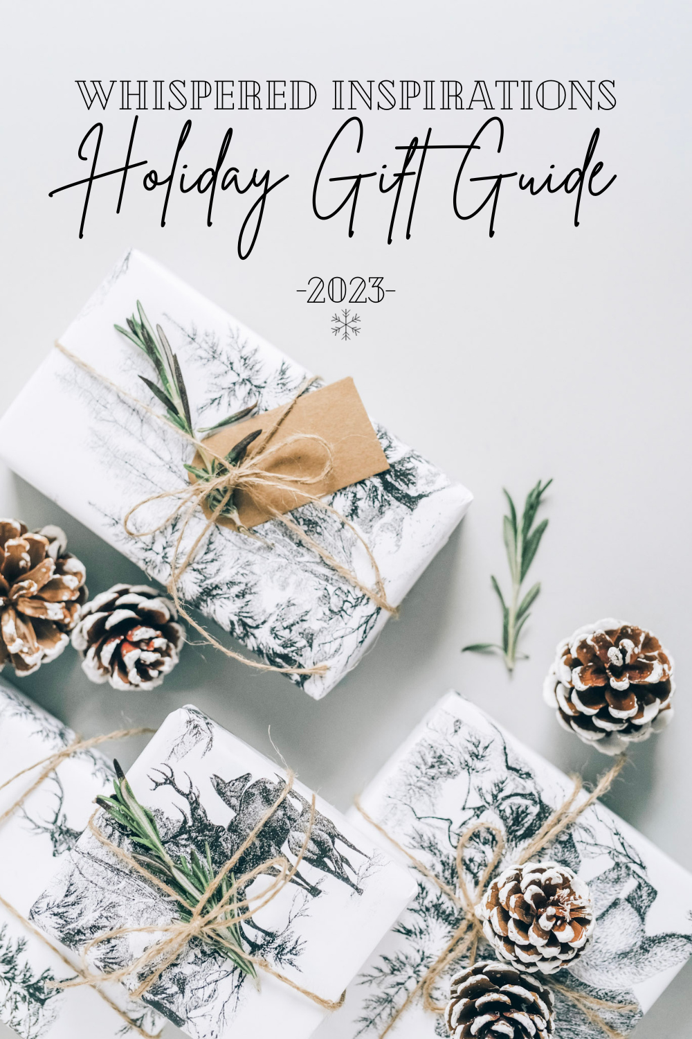 Beautiful gifts are wrapped in black and white wrapping with printed landscape. They are adorned with acorns and greenery and tied with twine. A banner reads, "Whispered Inspirations, Holiday Gift Guide, 2021.