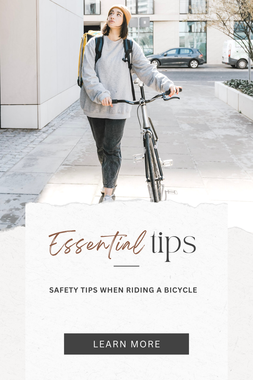 A girl casually walks through buildings while pushing a bicycle. The girl is looking up. This article covers 4 essential safety tips when riding a bicycle.
