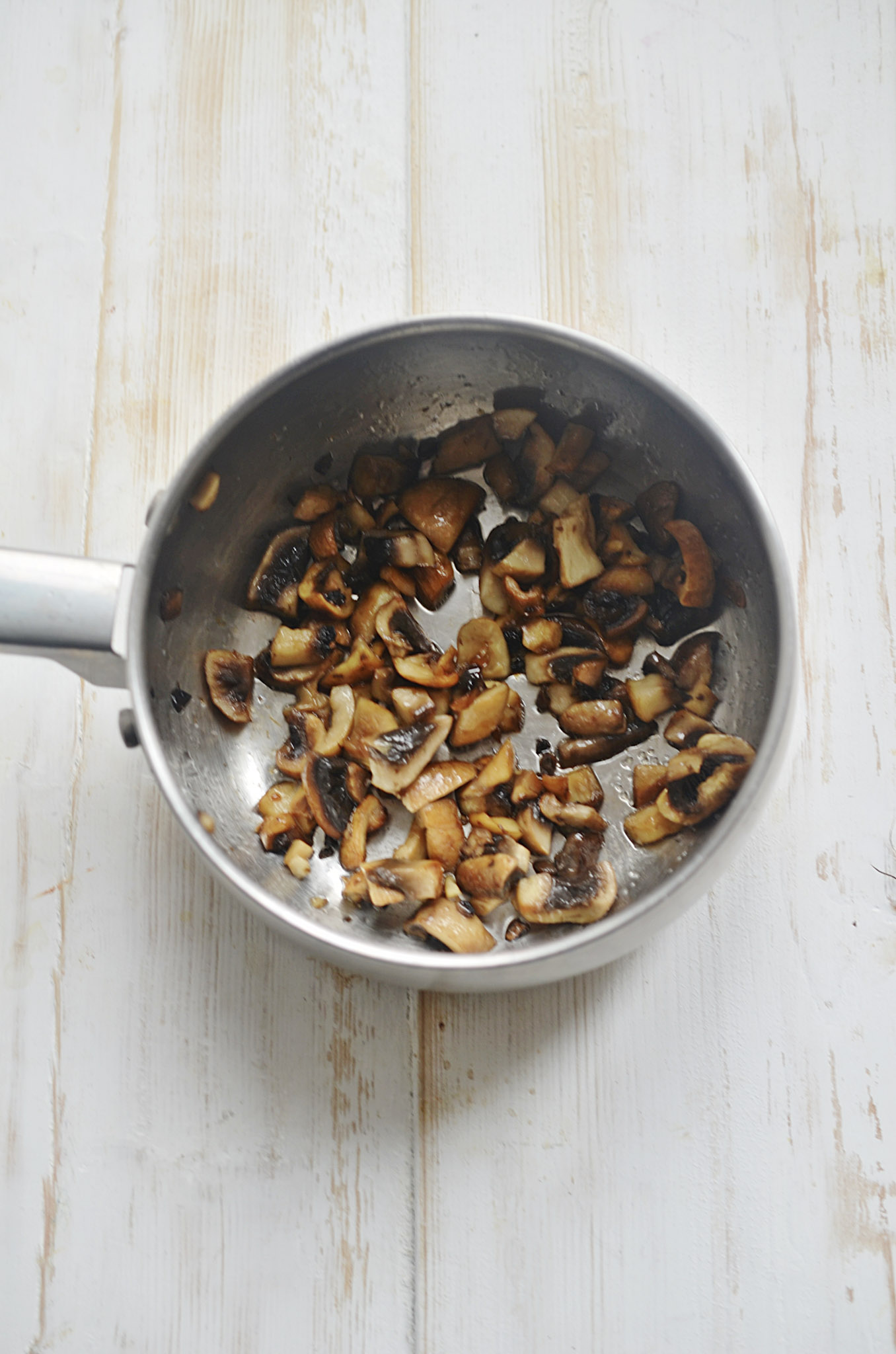 A pan with sautéed mushrooms. They are cremini mushrooms cooked to perfection. These mushrooms will be added to the Fully Loaded Burger Bowls.