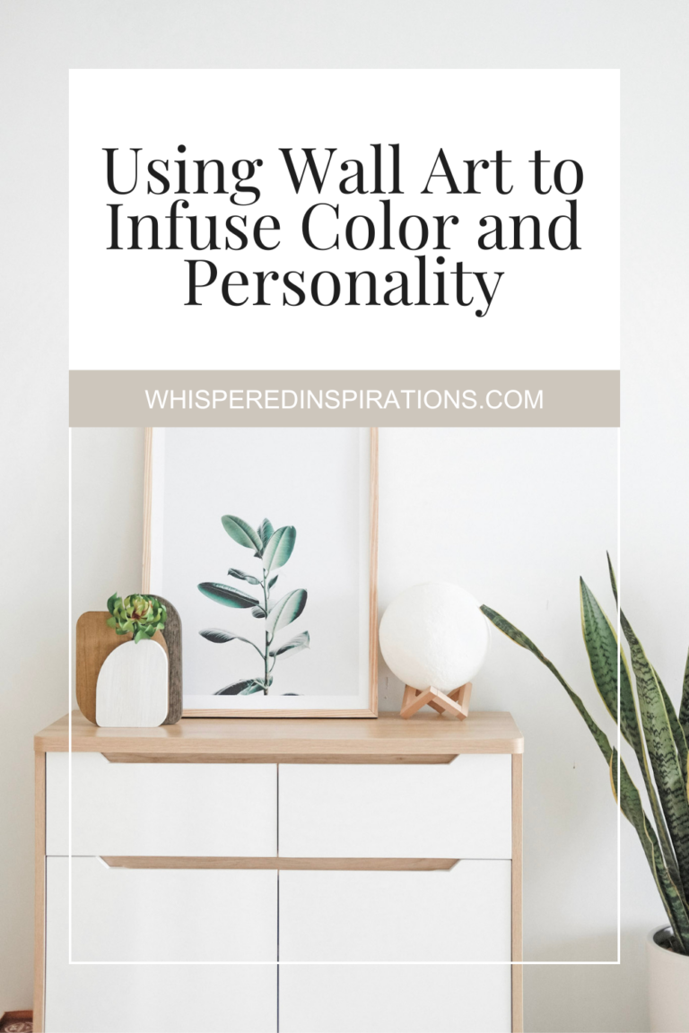 A white and natural wood night stand with wall art leaning. This article covers using wall art to infuse color and personality.
