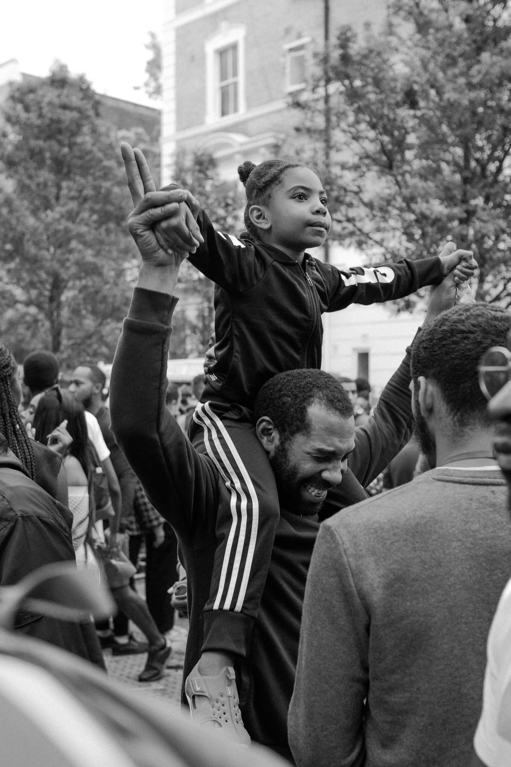 A father and child showed in a crowd. This article covers how to honor Black History Month in your community.