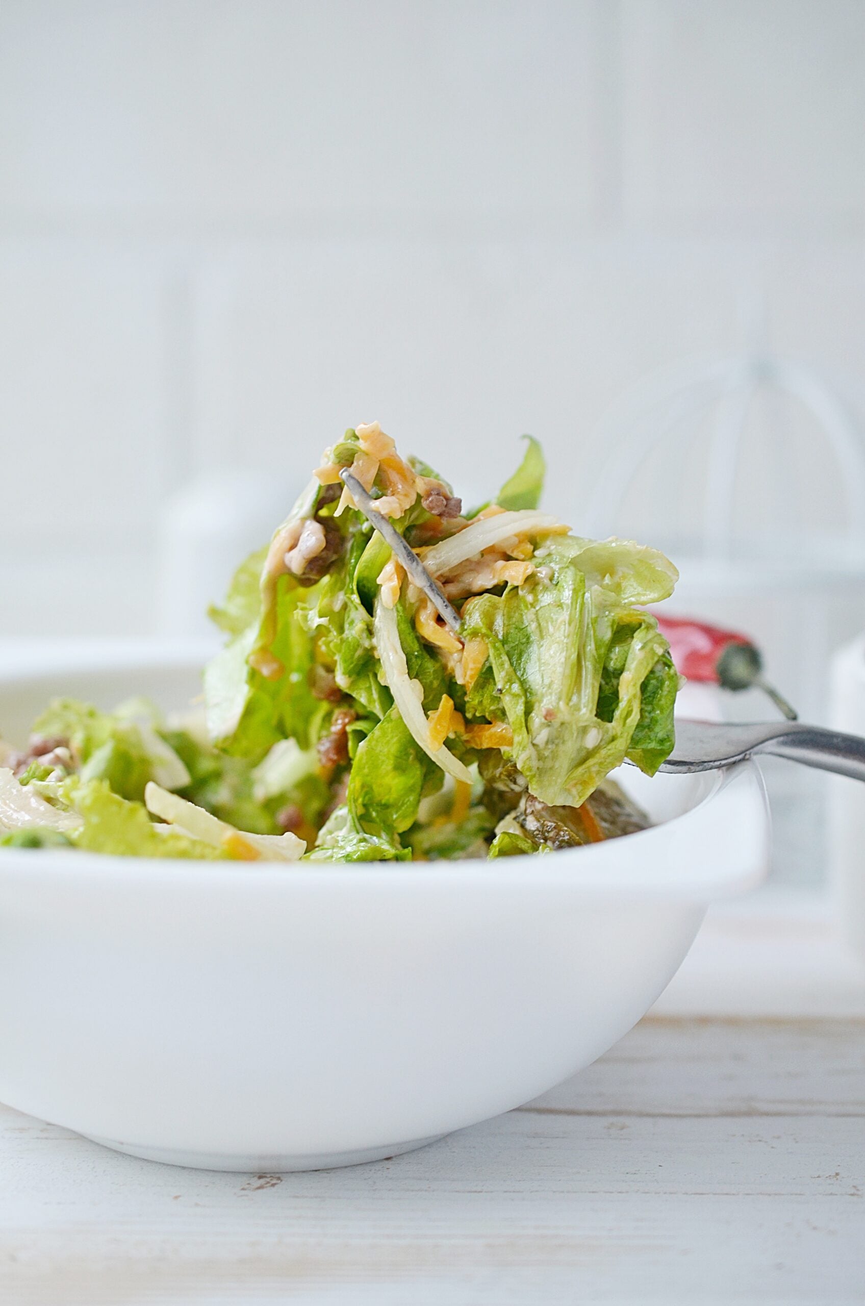 Showing off a bite of a Big Mac in a Bowl with a fork.