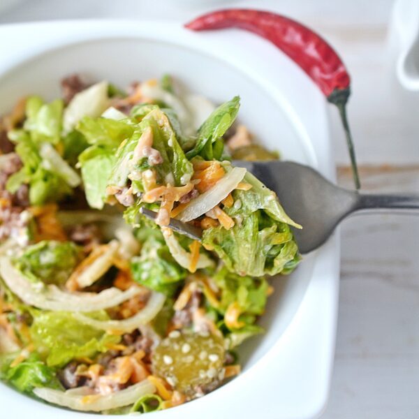 Big Mac in a Bowl recipe is shown in a white bowl with a fork.