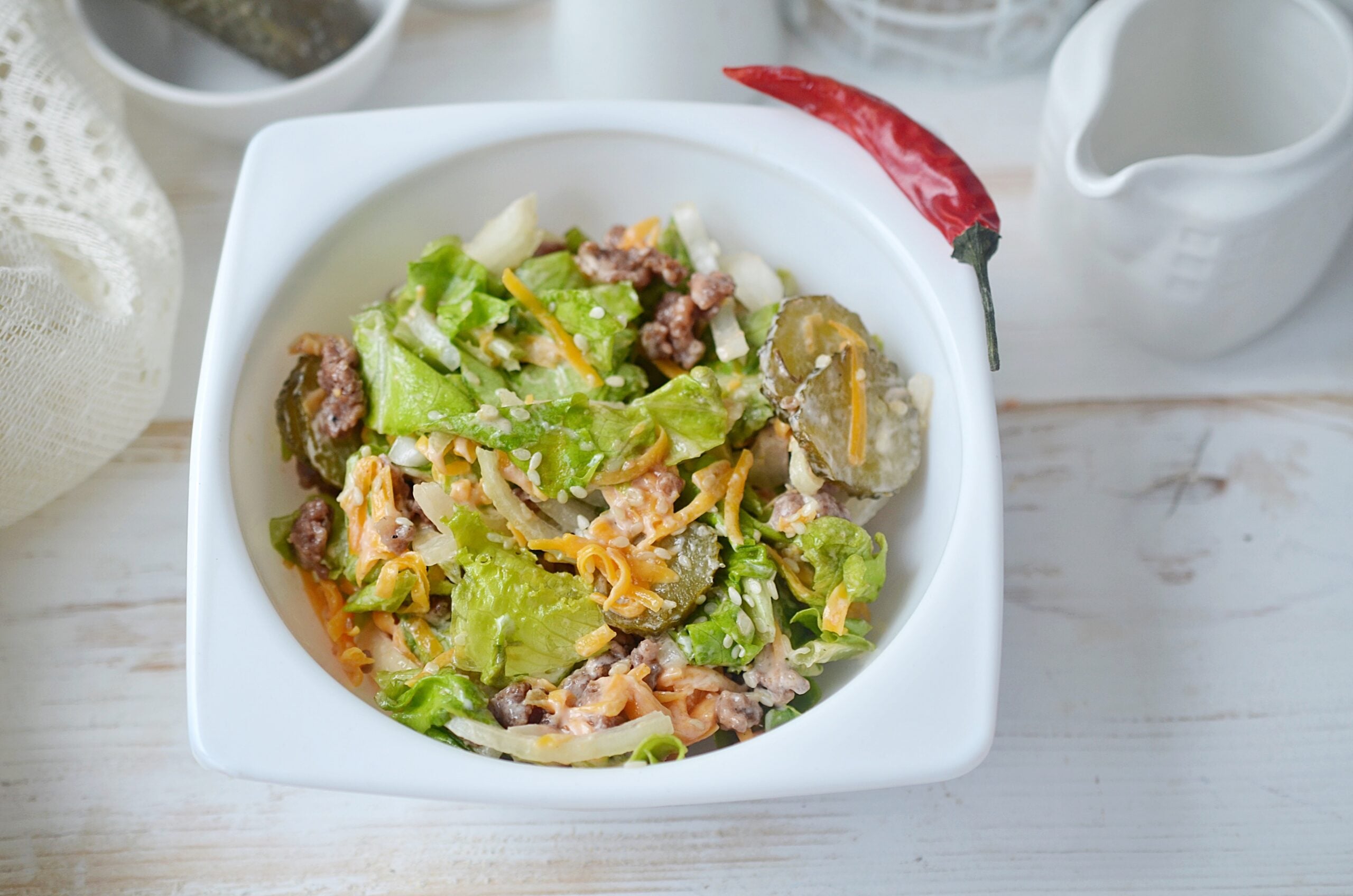 Mix the dressing and garnish to make the Big Mac in a Bowl.