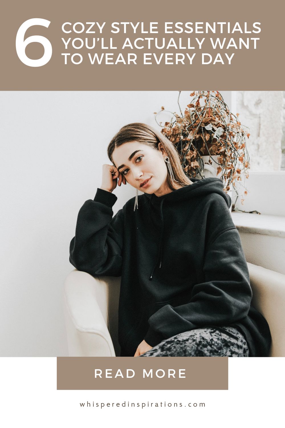 A girl wearing a black hoodie sits on a couch and poses for the camera. This article covers cozy style essentials you'll actually want to wear every day.