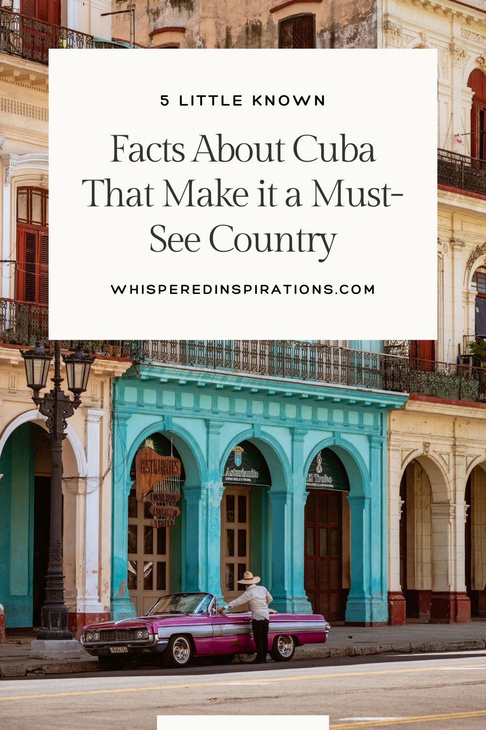 A man sits at his vintage car in Cuba, in front of the colorful buildings. This article covers facts about Cuba that make it a must-see country.