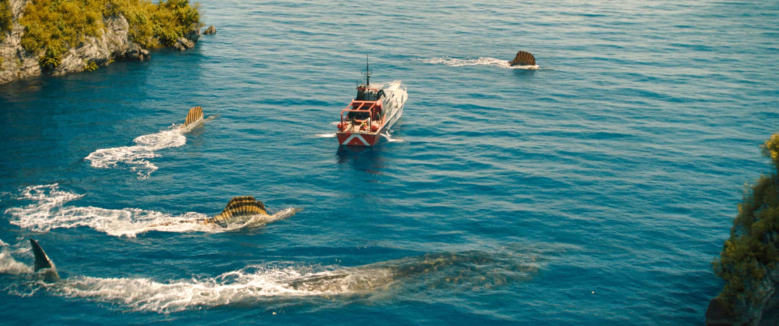 A vessel in the sea is surrounded by Spinosaurus', huge beasts with fans that stick out of the water. This is in Jurassic World: Rebirth