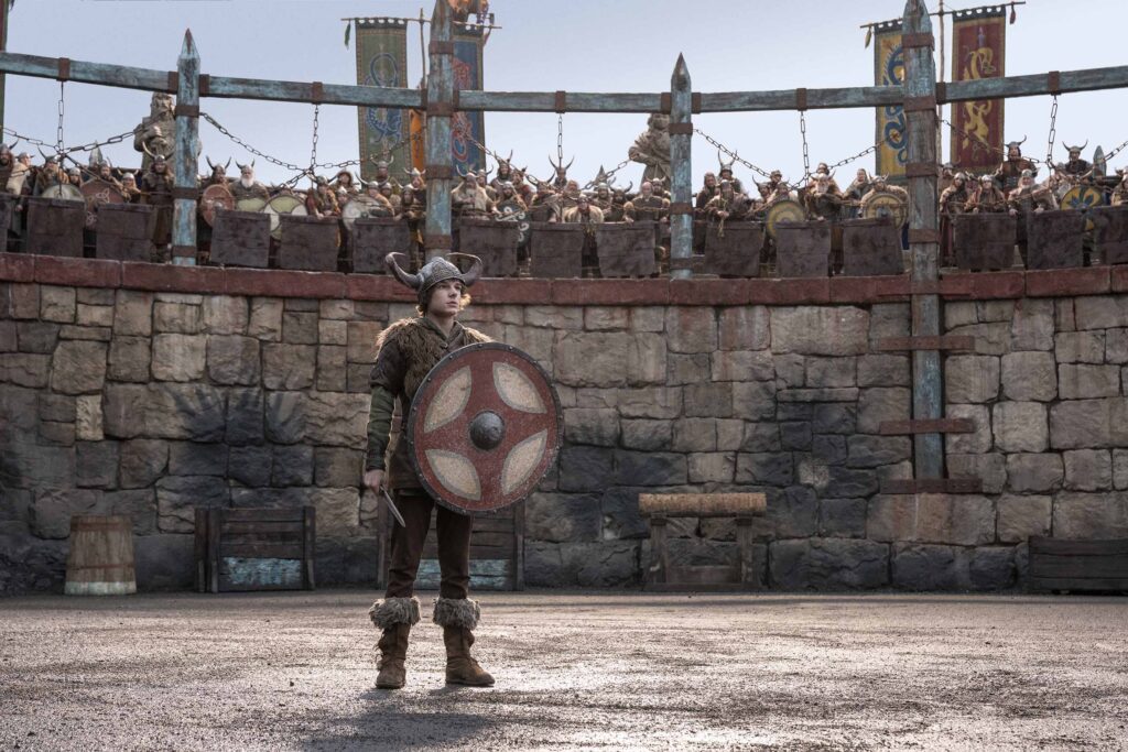 Hiccup stands in Viking gear while he trains for dragon slaying. This article shares why you shouldn't miss watching How to Train Your Dragon on June 13.