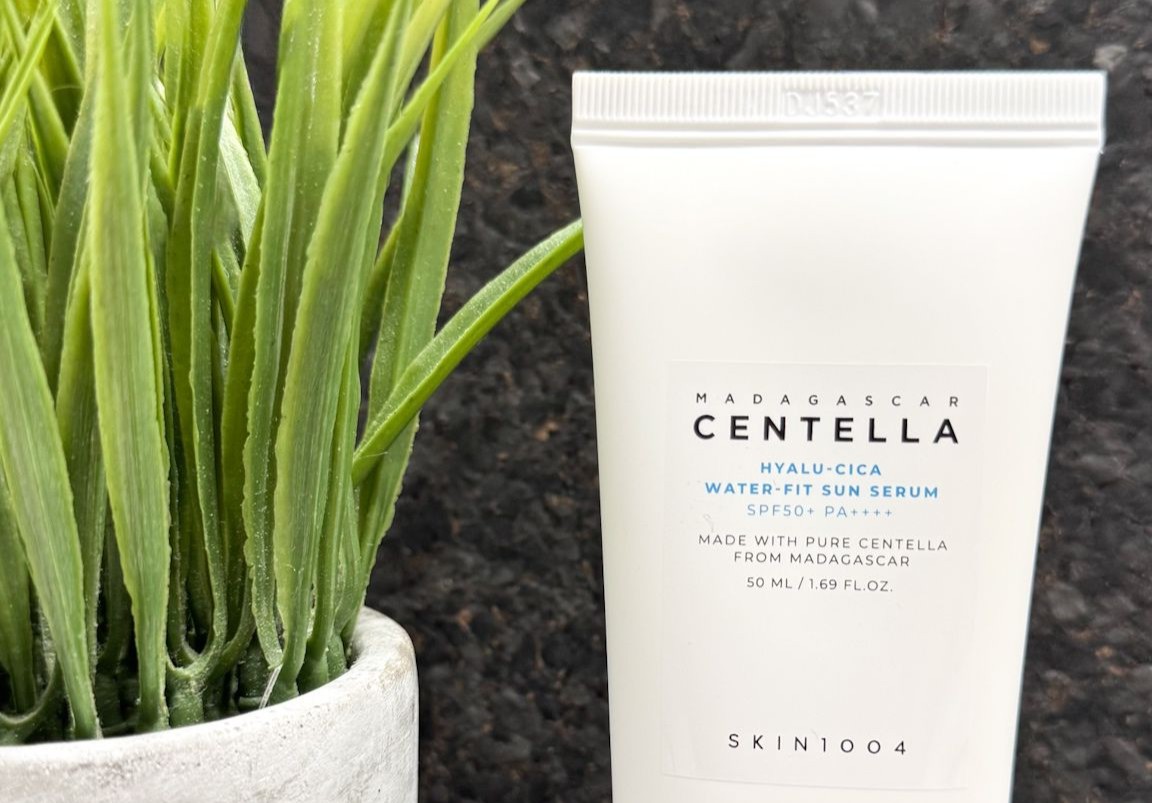 Skin1004 Centella Sunscreen next to a plant.