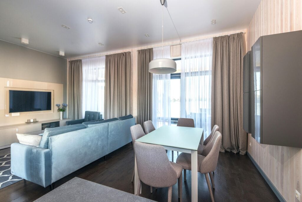 A beautiful, modern, apartment with a dining room and living room. This article covers what homeowners overlook in heating and cooling.