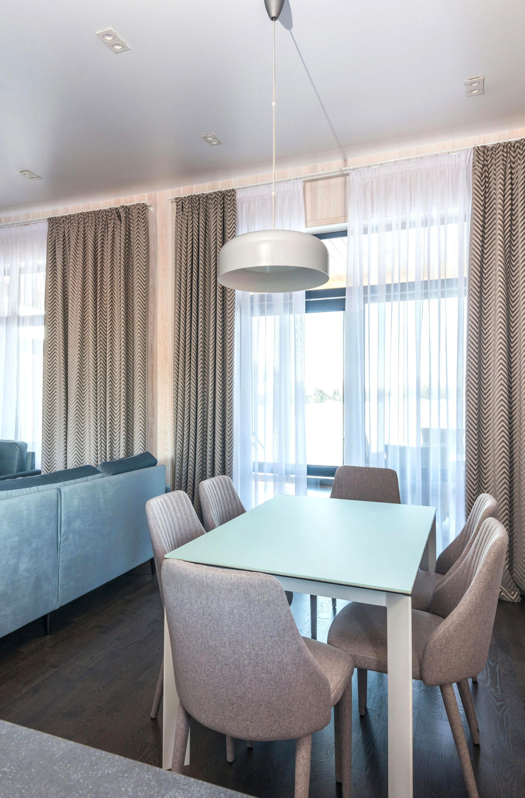 A beautiful, modern, apartment with a dining room and living room. This article covers what homeowners overlook in heating and cooling.