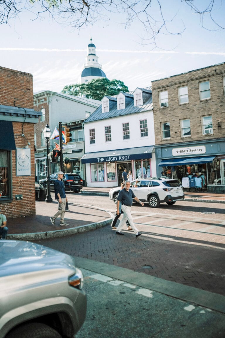 People walking across the street in Downtown, Annapolis, MD. This article covers the most walkable historic neighborhoods in America.