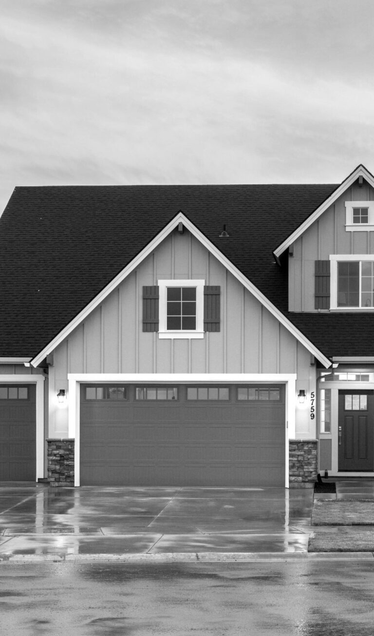 A house with a beautiful sunset behind it, shows a large garage. This article covers how to make your garage feel brand new.