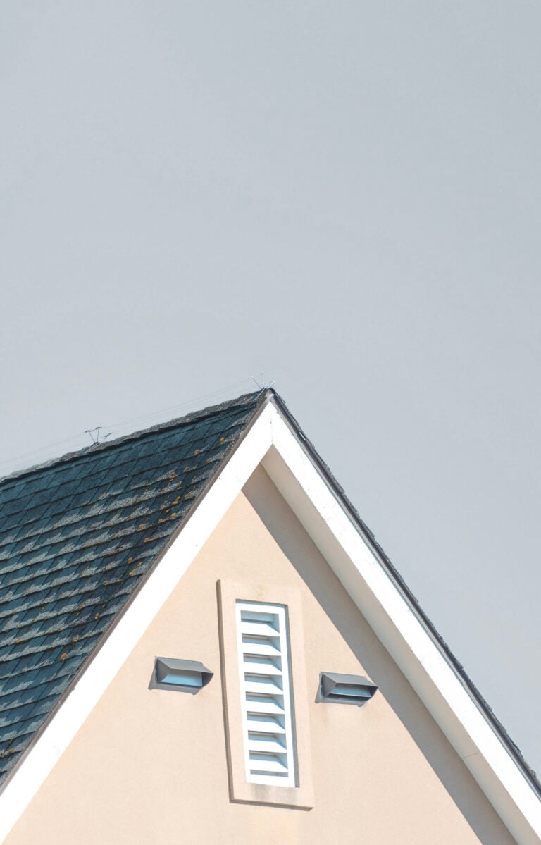 A roof of a home is pictured against a sky. This article answers the question, is your roof quietly warning you it's time for a change?