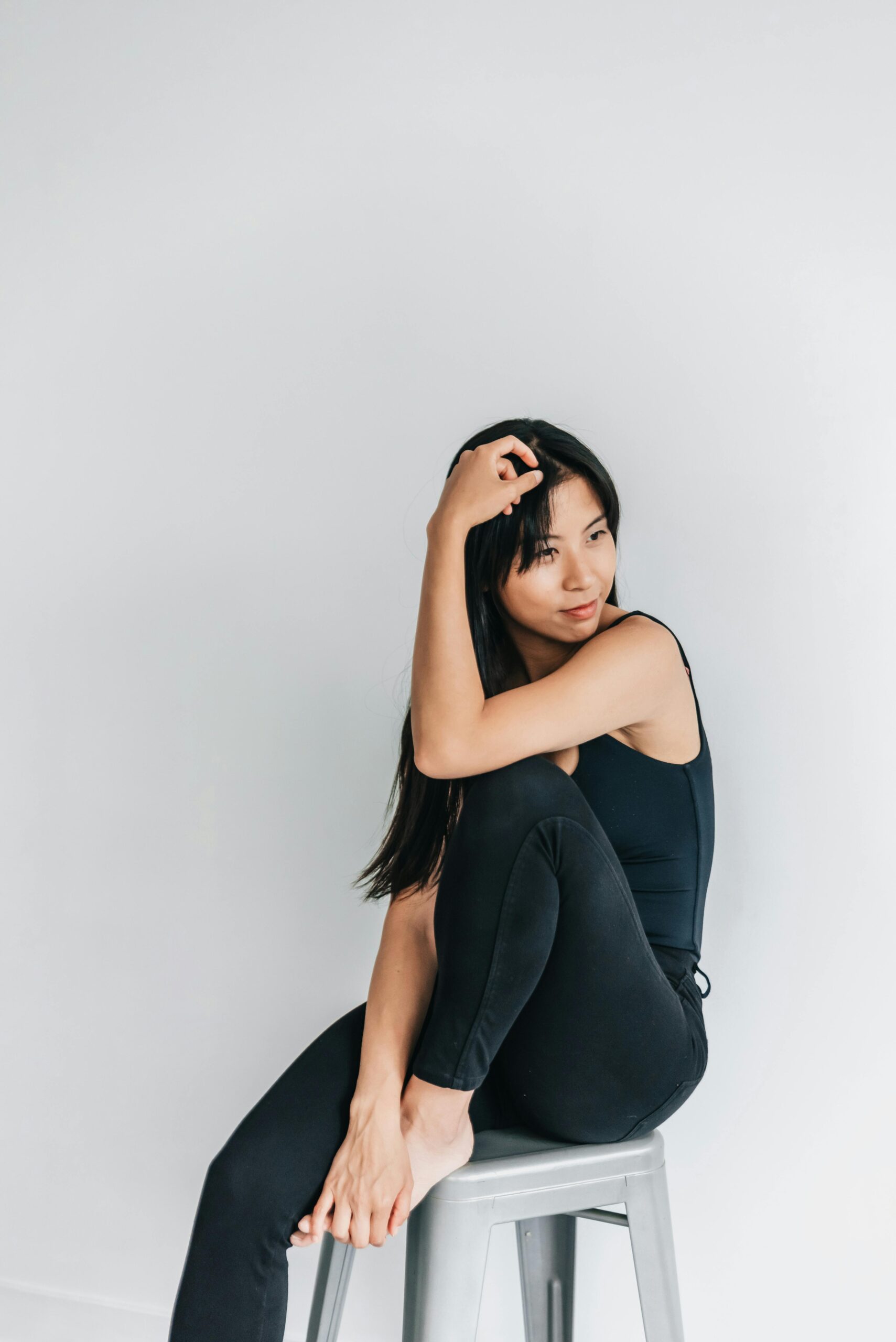 Woman wearing all black, posing for the camera. This article covers everyday wardrobe essentials.