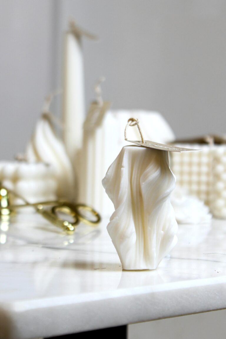 Aesthetic candle that are artistically shaped and beige in color. This article covers what mold shapes are most common for branded candle lines.