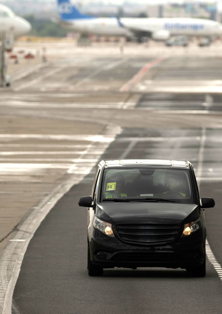 A private airport shuttle service at an airport. This article covers tips for stress-free airport transportation.