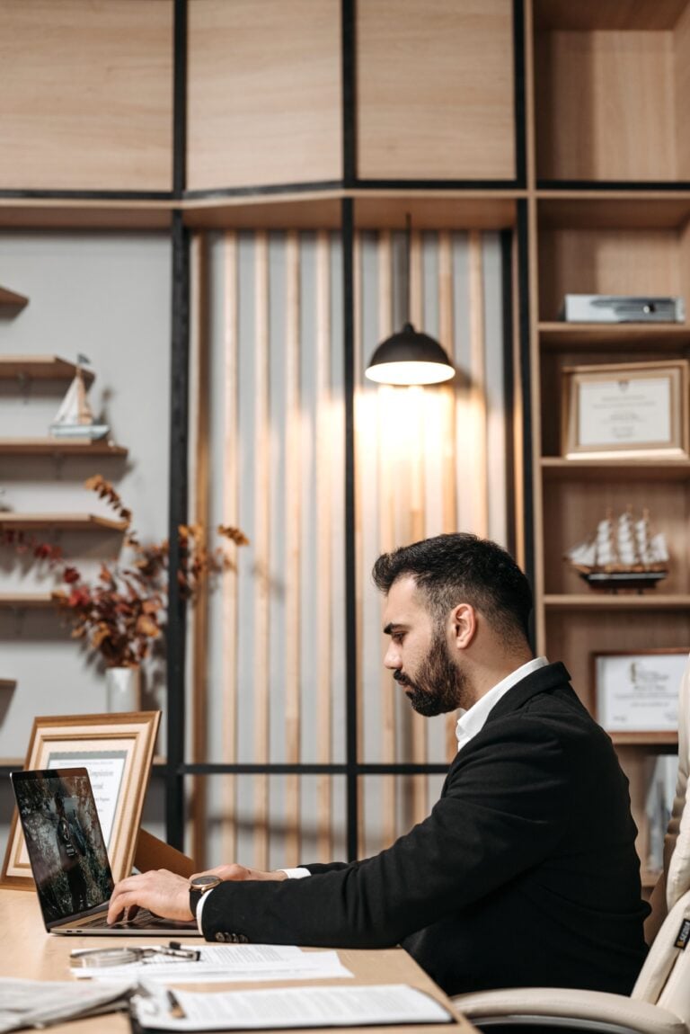 A young man sits at his desk and types on his laptop. This article covers 7 things nobody tells you about before calling a SSD law firm.
