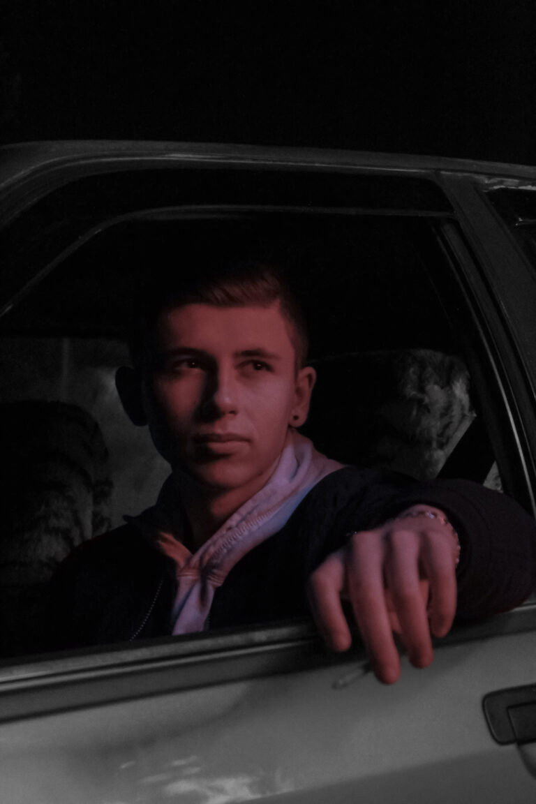 A young man sits stoically in his car with the window open. This article answers the questions, can a DUI charge be reduced?