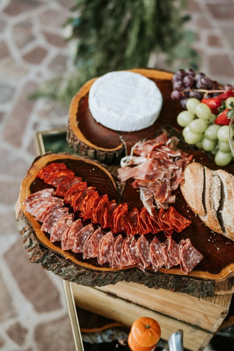 An inviting charcuterie board featuring meats, cheese, and fresh fruits on a wooden tray. This article covers how to create an unforgettable event menu.