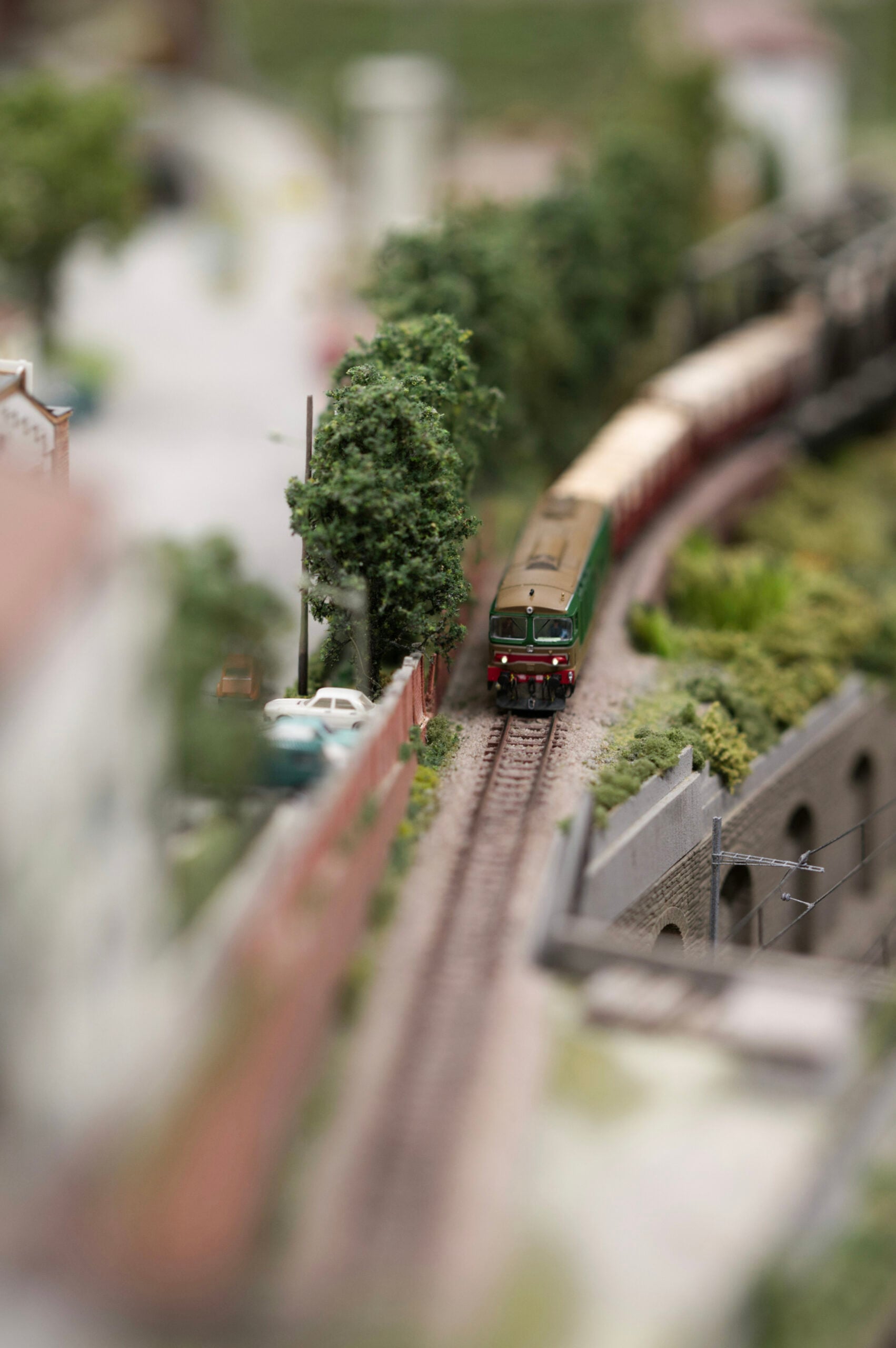 A close up of a miniature train and track within a miniature landscape. This article shares how to start a miniature building hobby with your kids this weekend.