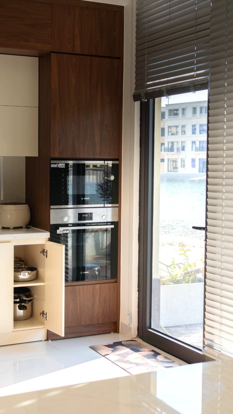 A modern kitchen with warm cabinets and modern appliances. This article covers modern kitchen cabinet trends shaping today's homes.