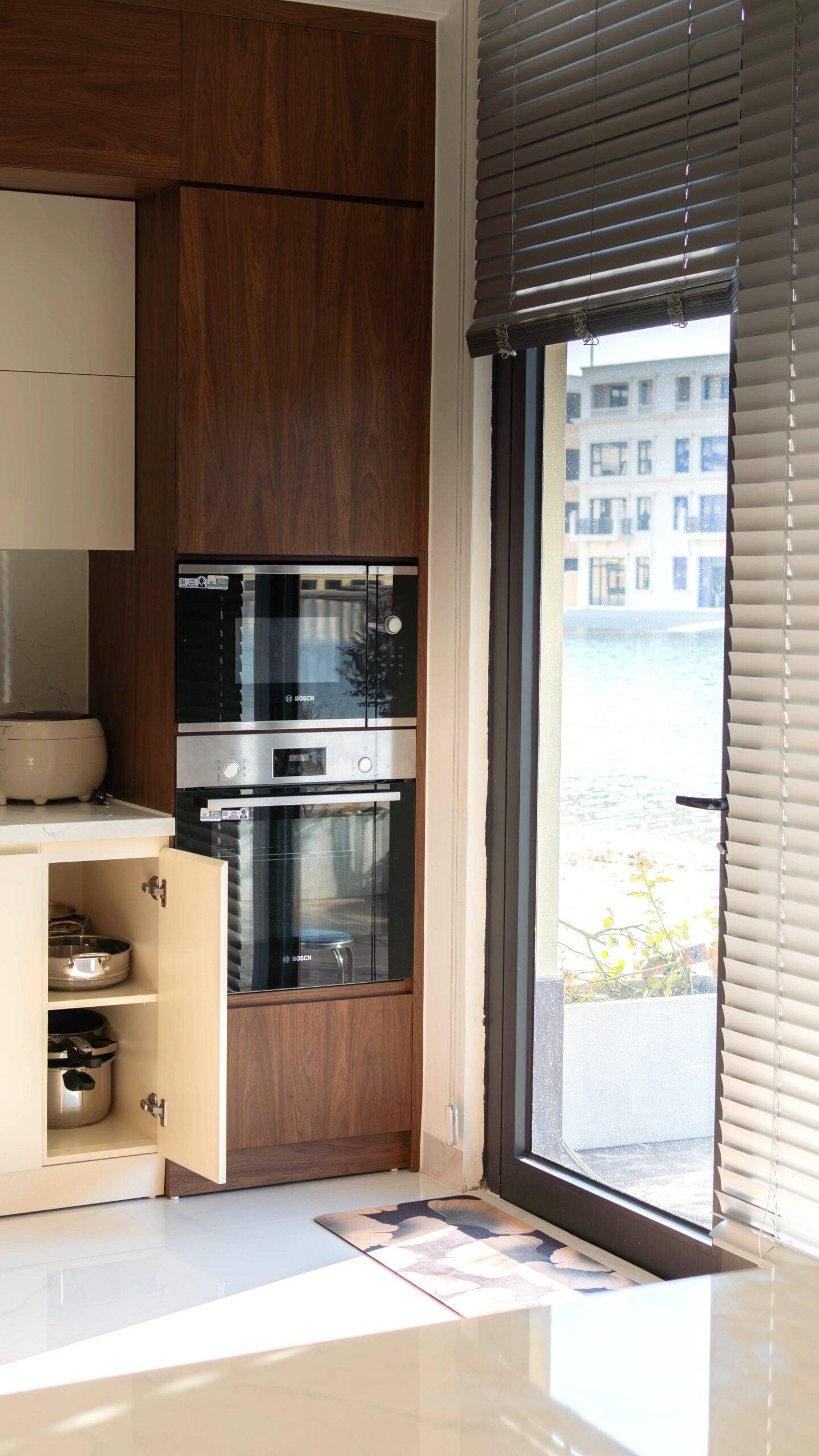 A modern kitchen with warm cabinets and modern appliances. This article covers modern kitchen cabinet trends shaping today's homes.