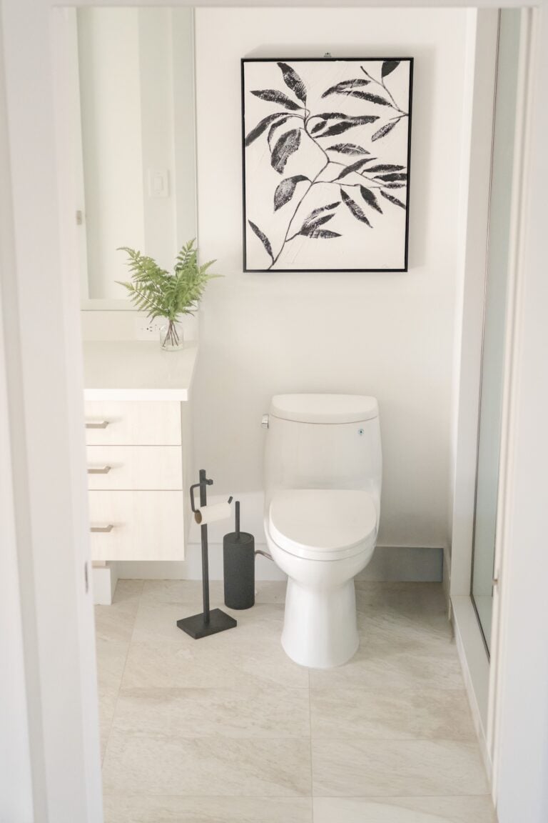 Bright minimalist bathroom showcasing a modern toilet with artistic decor. This article covers easy bathroom updates that add comfort and style.