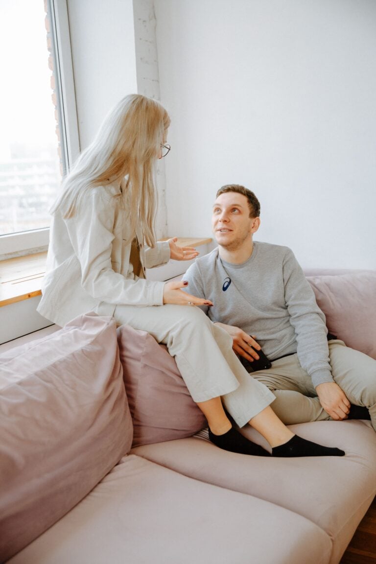 A couple sit on a couch and look like they are having a deep conversation. This article discusses what the legal rights for unmarried couples.