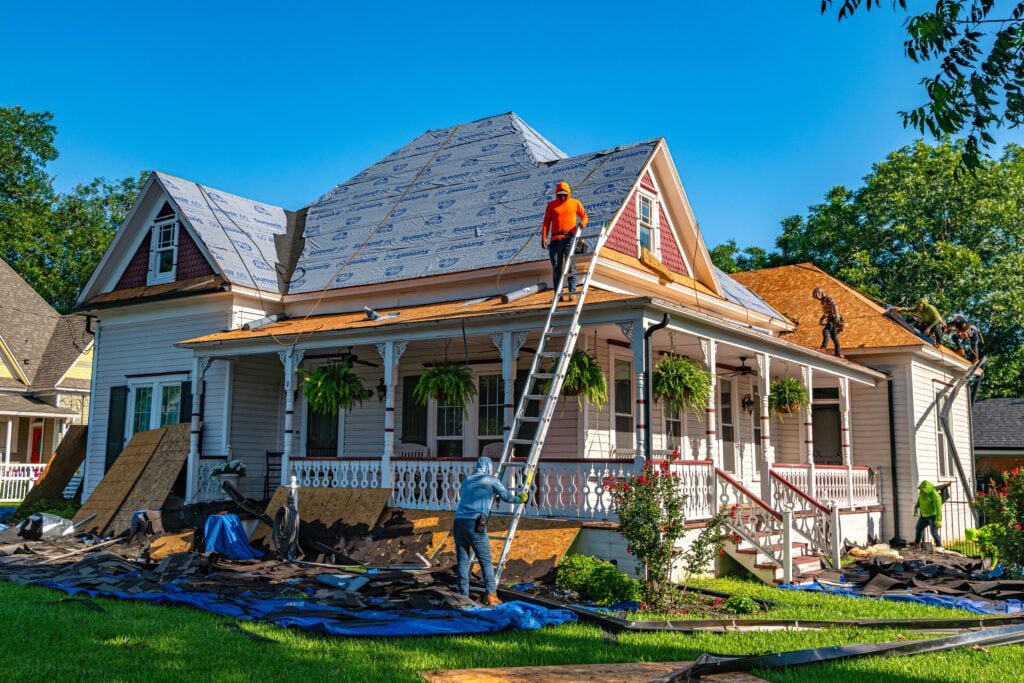 Roofers replace the roof of a historic home in Weatherford, Texas. This article shares how to plan a roof replacement without losing your mind.