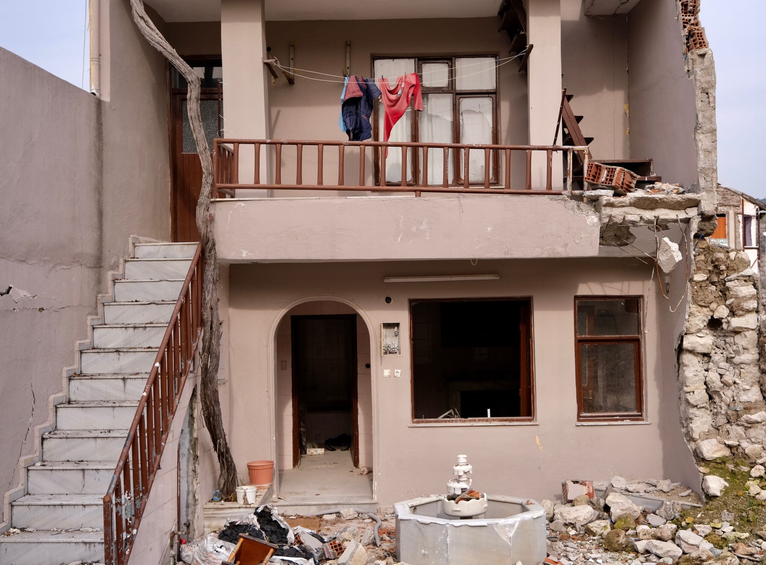 Damaged residential building facade. This article shares what to know before you rebuild after major home damage.